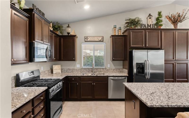 Granite counter tops & wood panel cabinets