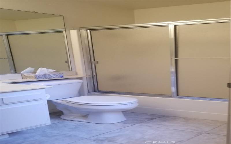 Three-piece bathroom includes tub/shower combination, sink and toilet.