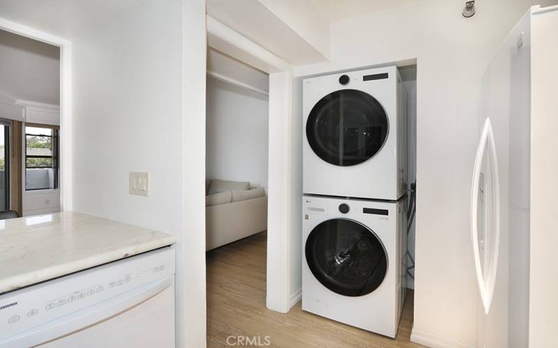 Modern and new laundry sits conveniently at end of kitchen space