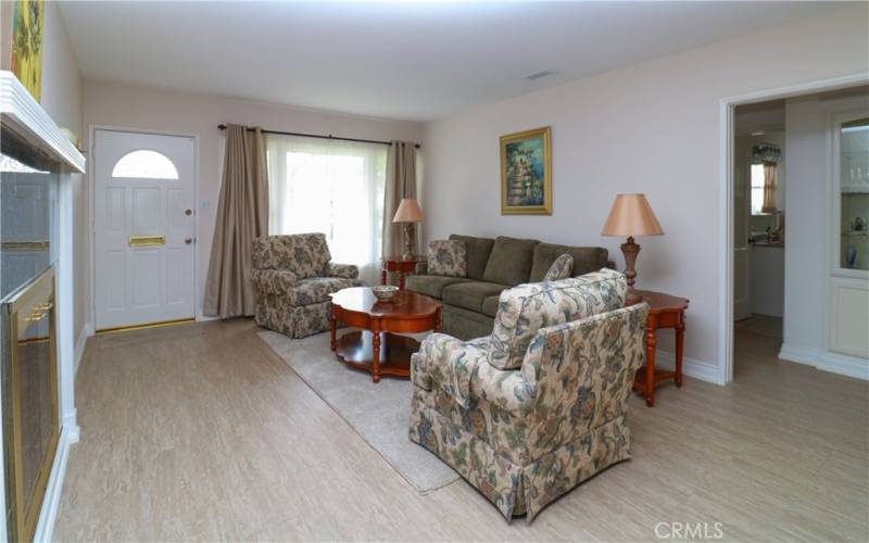 View of hall off of living room w/ built-n custom china cabinet and front bedrooms and bath.