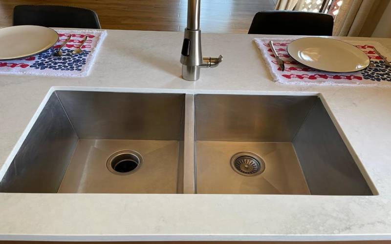 Kitchen stainless double basin sink. Convenient bar for that quick meal. Got to get to work honey