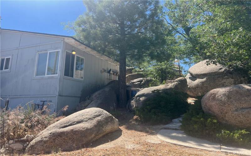 Cabin sits amount the boulders.