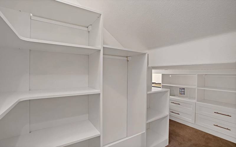 Fully customized closet under stairs provides lots of storage