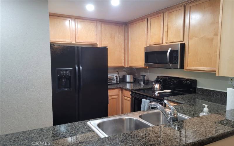 Kitchen with appliances included in the sale (refrigerator and stove)