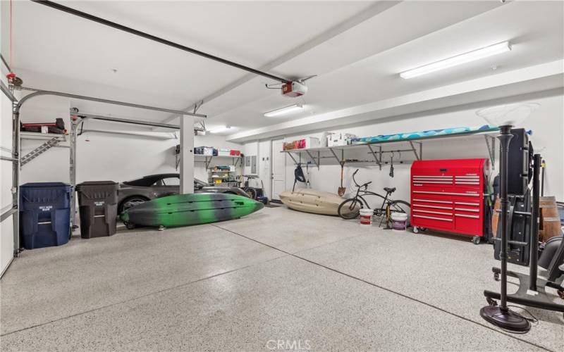 Beautiful THREE CAR GARAGE with epoxy floor and extra shelving.