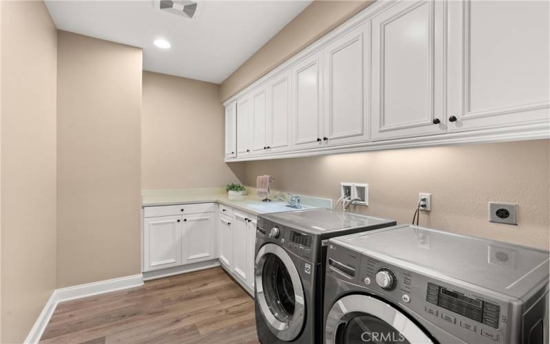 Dedicated Laundry Room with lots of cabinets.
