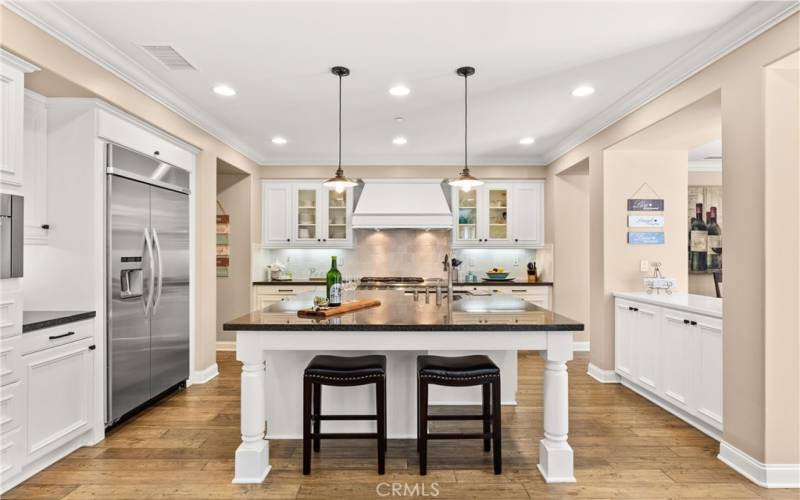 High-end Custom Cabinetry, Stone Counters, Beautiful Appliances. and Large Center Island open to Living Room and Dining Room.