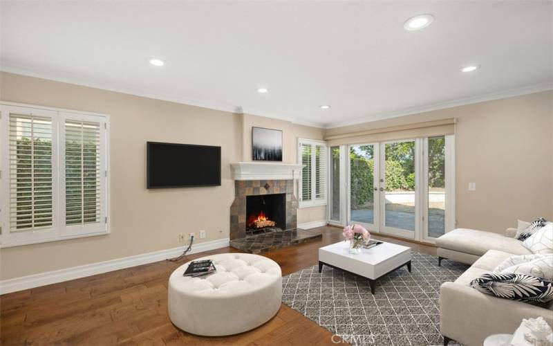 Beautiful family room with glass doors & fireplace.

Note: Photo is virtually staged.