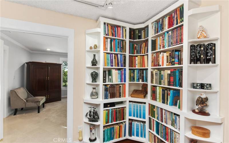 Hallway - Custom corner shelving- perfect for books and displaying pieces of art.