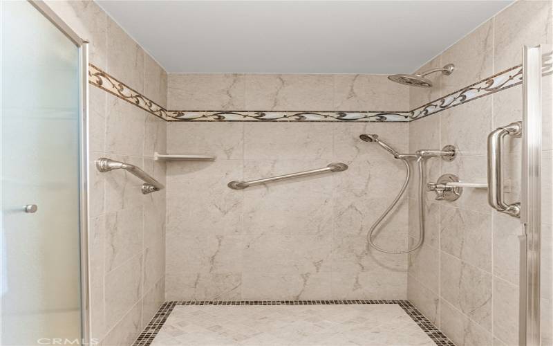 Multi-head tile enclosed shower.