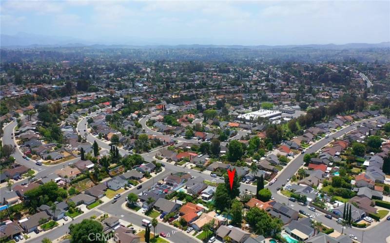 aerial property view shows proximity to school and neighborhood
