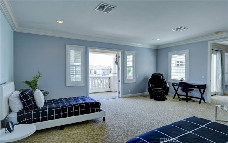 Bonus room with double doors to a balcony.