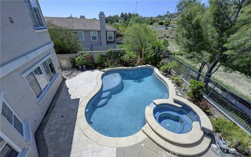 View from primary ensuite bedroom to the relaxing pool & spa