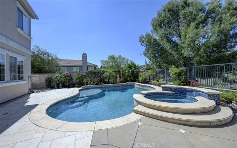 Private backyard pool with Baha seating, spa and waterfall.