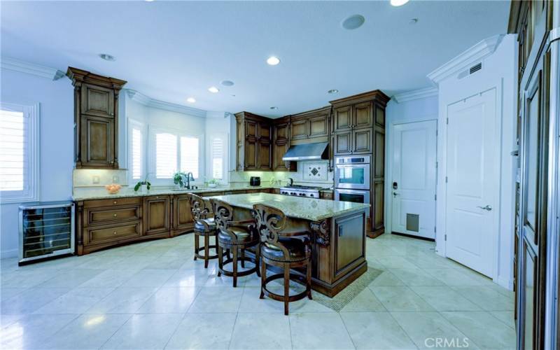 Expansive kitchen with door to the two car garage and a walk in pantry.