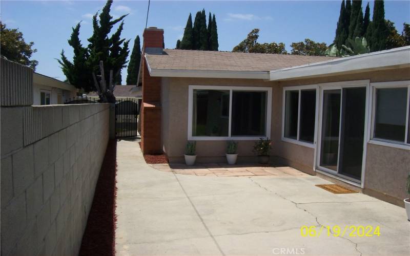 View Of Open Patio Deck, Fireplace And Side Gate