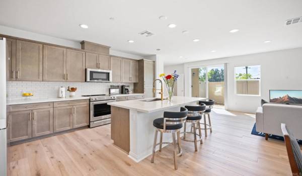 Beautiful kitchen includes upgraded luxury counter top and cabinetry. Luxury wood looking vinyl.