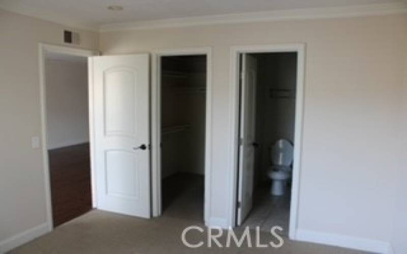 Walk-in closet and full bathroom in primary bedroom