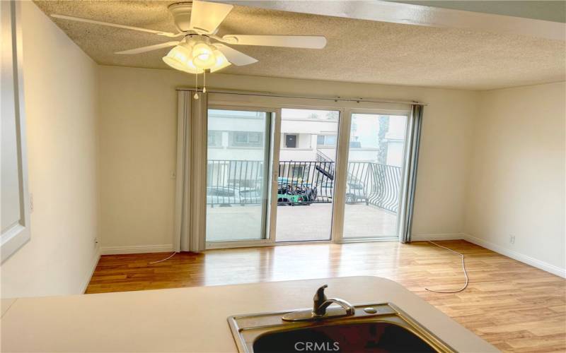 Living area with slider to large deck with white water views.