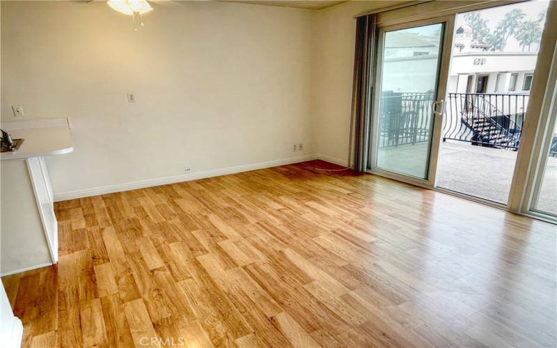 Living area with slider to large deck with white water views.