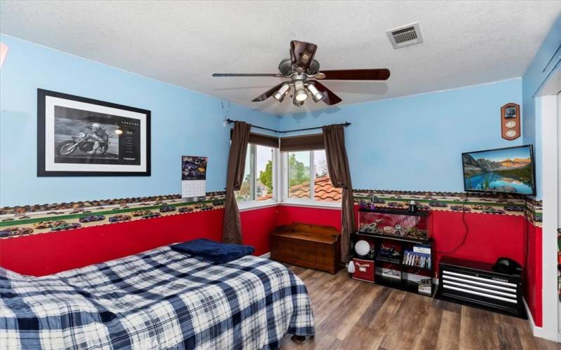 third updtairs bedroom with lighted ceiling fan