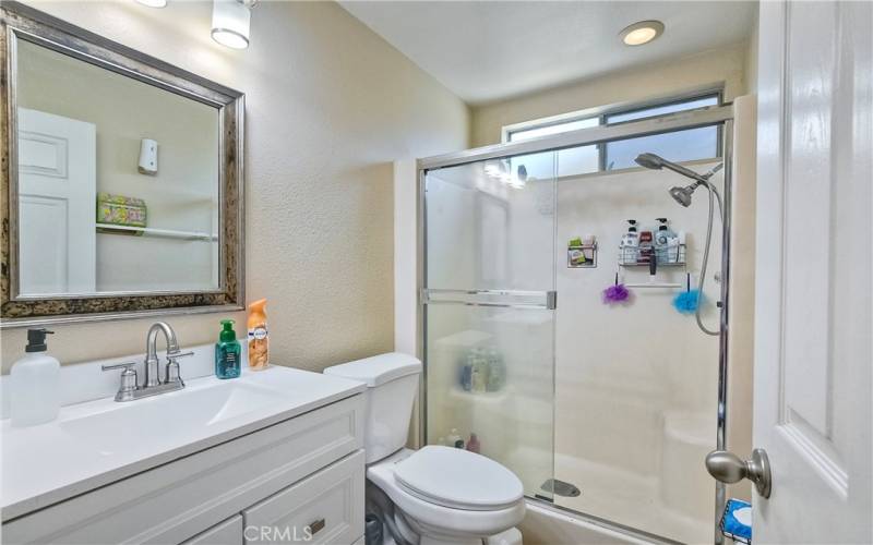 Ensuite primary bath with newer vanity and a step-in shower