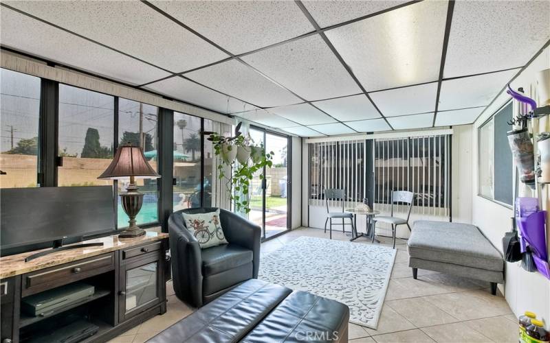 Garden room with sliding door and windows that surround the room