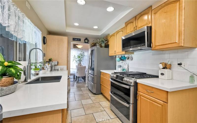 All you could want in the inviting kitchen, pull out drawers, near new stainless appliances, plus the sunlit kitchenette in the distance