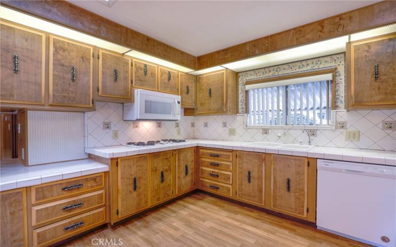 The kitchen offers abundant cabinetry for storage and ample counterspace for preparing meals.