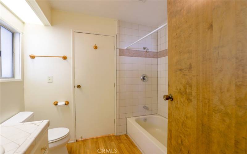 The main bathroom is connected to the guest bedroom and can be accessed through the laundry room.