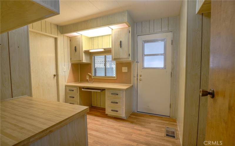 The laundry room has a built in desk and door that leads out to the carport.