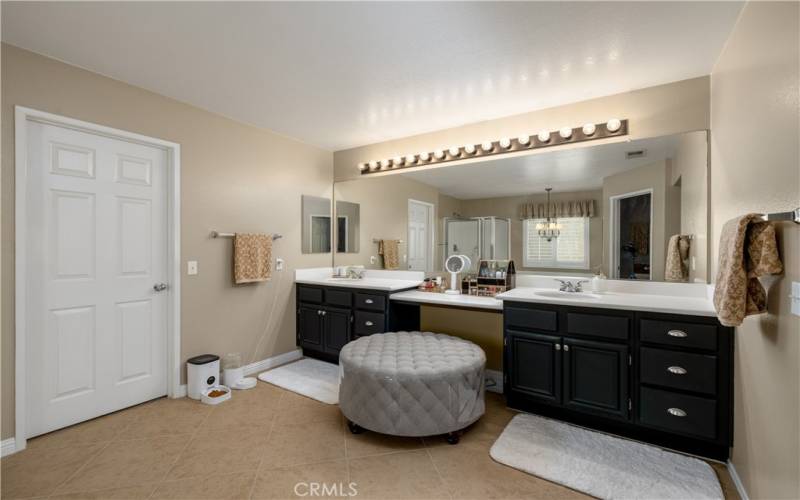 Generous primary bathroom with double sink vanity.