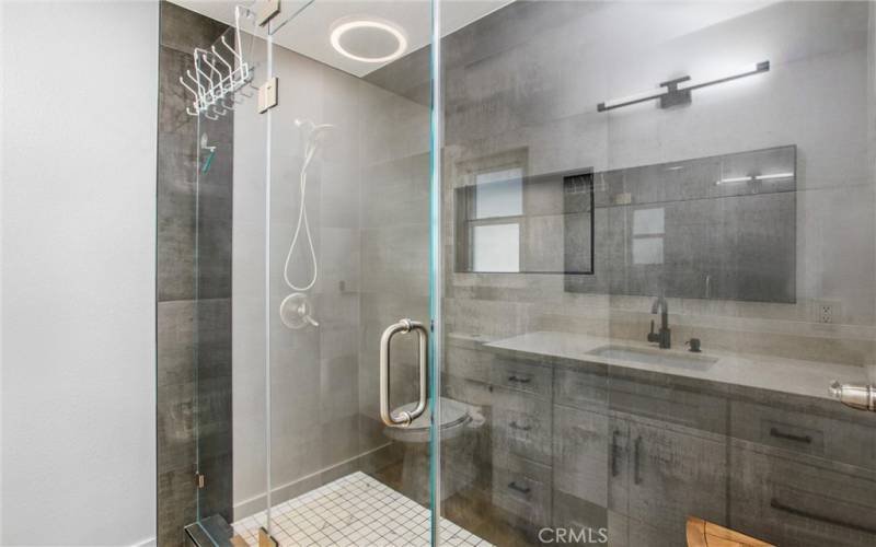 UPDATED SHOWER WITH LARGE 14 X 29 TILES AND GLASS ENCLOSURE
