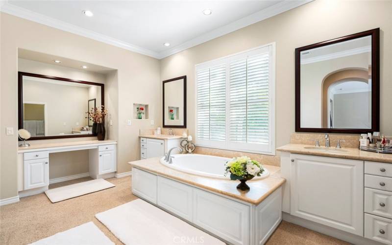Primary bathroom with double sinks, vanities, soak tub and separate shower.