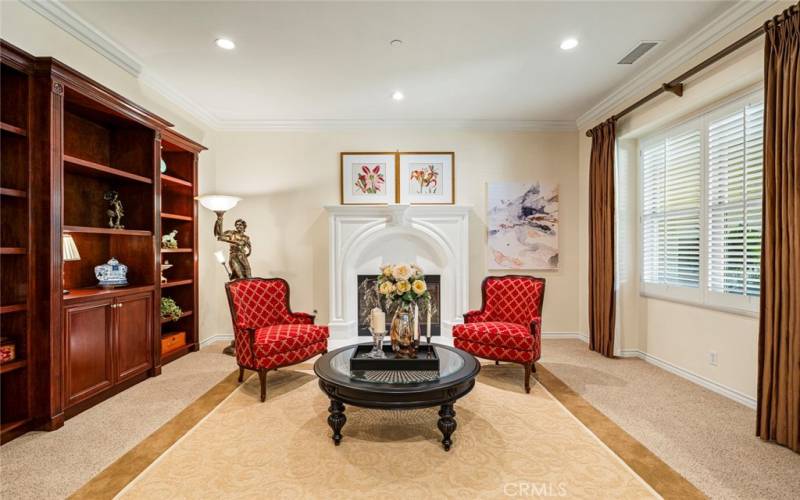 Living room with custom designed fireplace and built-in shelves