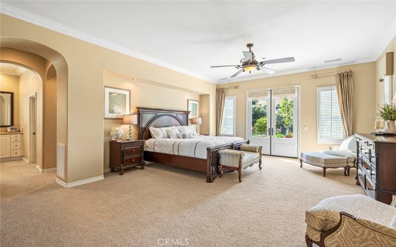 Large primary bedroom has French door to the backyard, private retreat area and large walk-in closet.