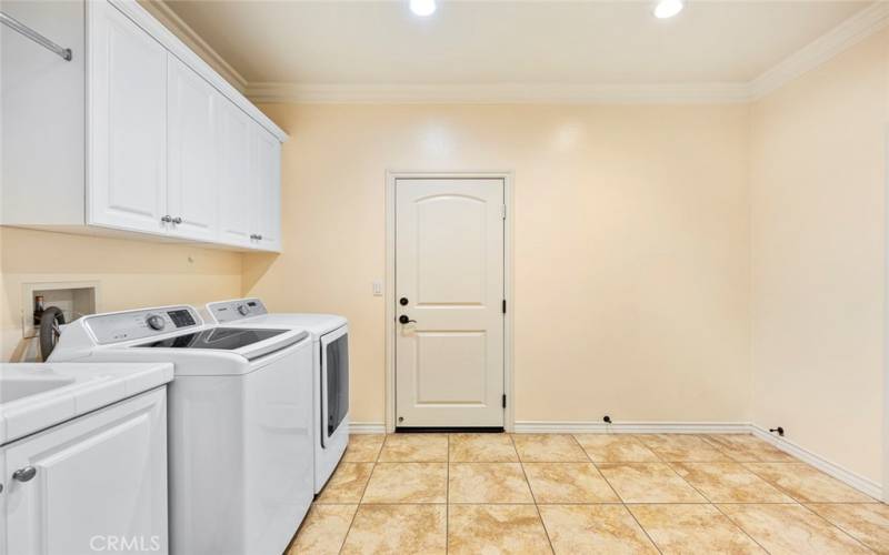 Spacious laundry room with sink and storage.