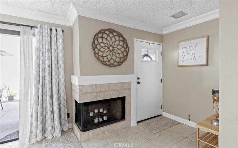 View of the front door and fireplace.