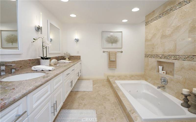 Tastefully remodeled primary bathroom with a jacuzzi tub