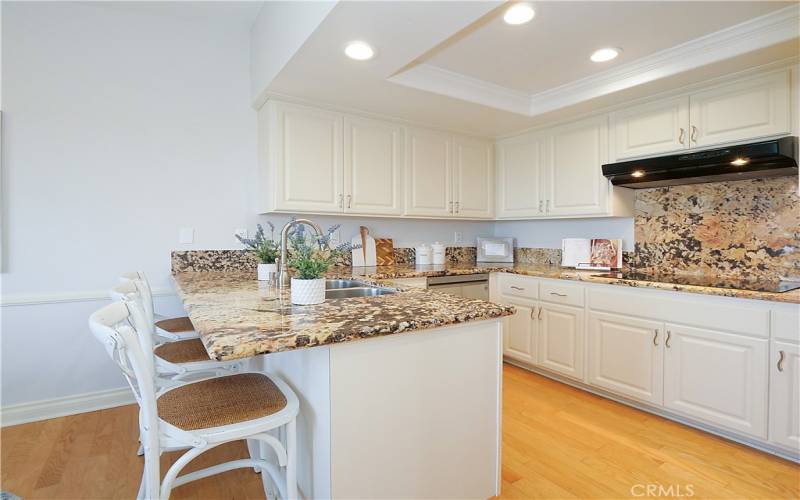 Remodeled kitchen with granite countertops and sitting island