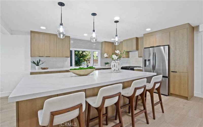 Gourmet chef-style kitchen fitted with professional grade appliances, a large center island, and custom cabinetry