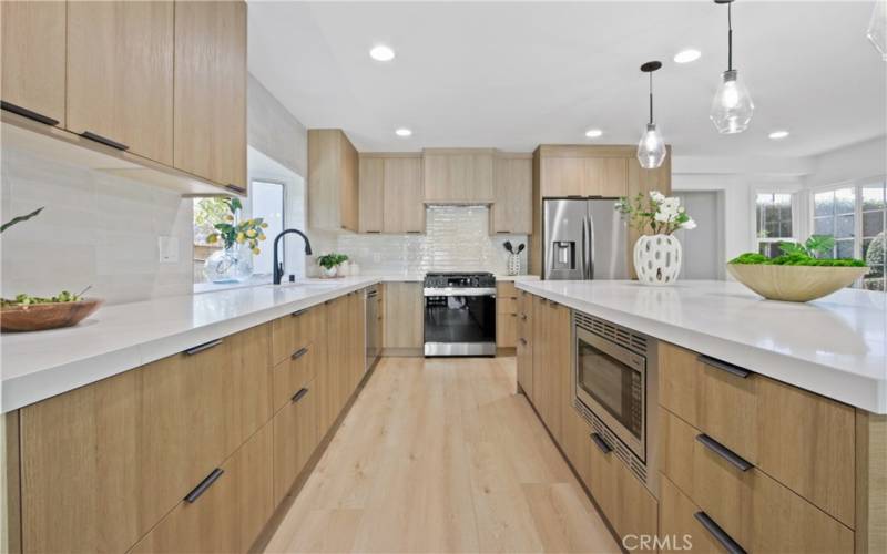 Gourmet chef-style kitchen fitted with professional grade appliances, a large center island, and custom cabinetry