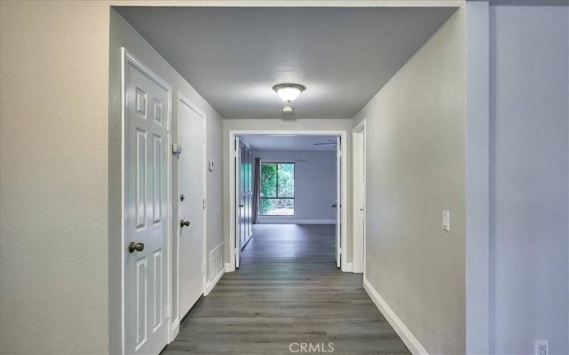 Wide hall way! Leads to Primary bedroom suite and 1 guest bathroom.