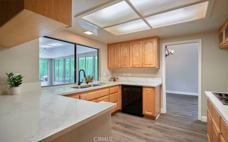 Kitchen window opens to sunroom