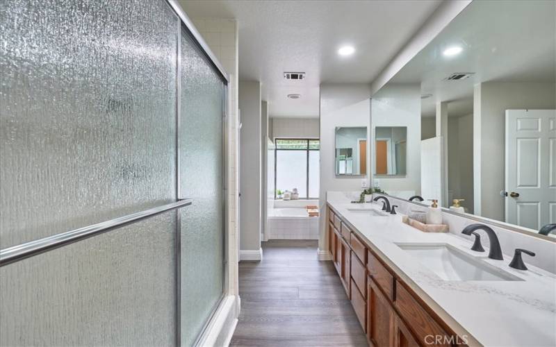 Primary bathroom double sink, plenty of storage, large separate shower, soaker tub and private water closet.  New sleek  quartz counters and fixtures