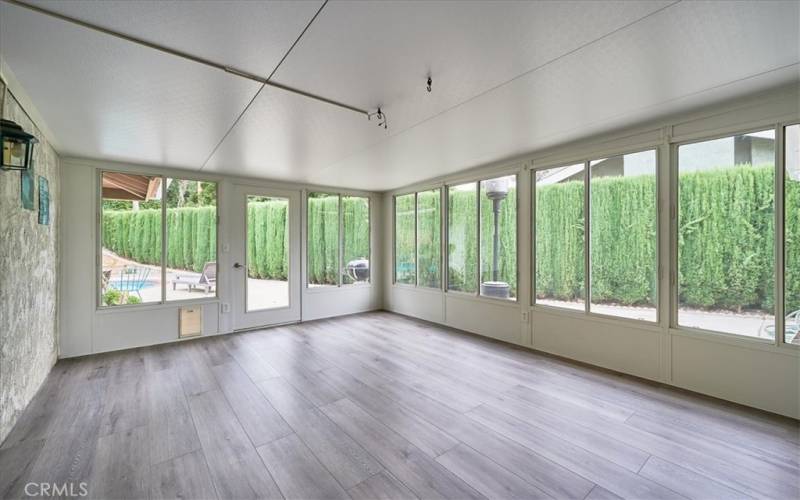 Wonderful entertainment area /sunroom with a window that opens to the kitchen.