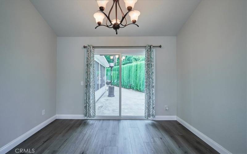 Formal dining room with slider that opens to backyard. Perfect for entertaining and barbecues at the pool!