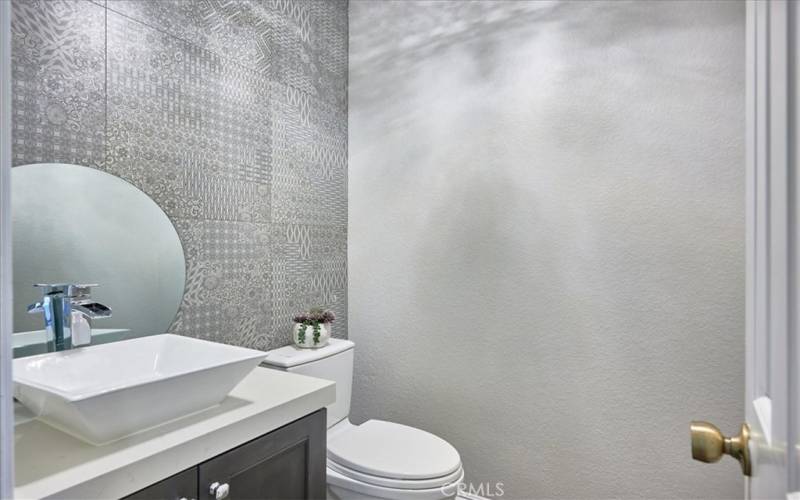 Guest bathroom. Gorgeous wall treatment, remodeled with beautiful fixtures and lighting.