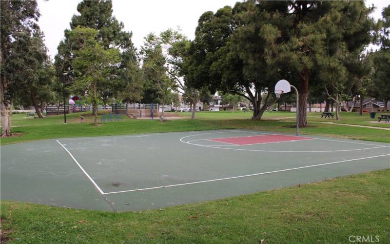 Half basketball court near the swings