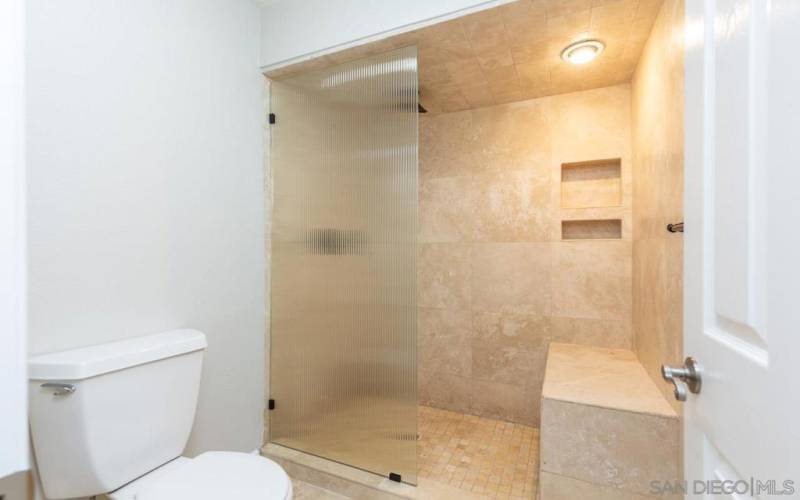 Primary bathroom with a custom shower.